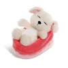 Cuddly toy dog in red-pink basket